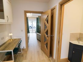 A hallway with a desk and lamp at The Barn in Astwood Bank