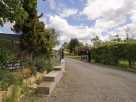 A driveway with a gate and sign at The Barn in Astwood Bank