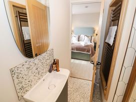 A bathroom with a sink and mirror at Bay House Cottage in Broadway