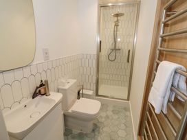 A bathroom with a shower and sink at Bay House Cottage in Broadway