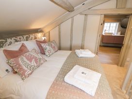 A bedroom with a bed and pillows at Bay House Cottage in Broadway