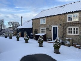 A house with snow and plant pots at A Stones Throw Sawdon near East Ayton