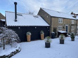A house and garage covered in snow at A Stones Throw in Sawdon near East Ayton