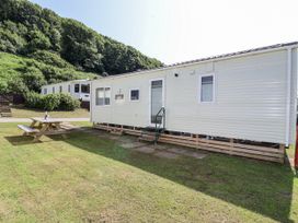 A caravan with a picnic table in front at Caravan 7 Plymouth