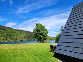 A view of a lake with trees and mountains at Lodge 2 - Inglewood Lodge Spean Bridge