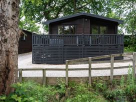A cabin with a deck and fence at Watendlath in Keswick