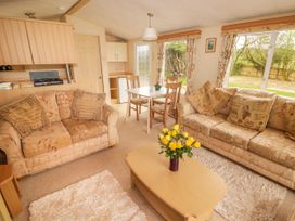 A living room with sofas table and dining area at Grandads Shack Trevethin near Pontynewynydd