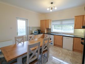 A kitchen with table and chairs at No 1 Lodge Wood, Kenmare, County Kerry