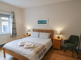 A bedroom with a bed and nightstands at No 1 Lodge Wood, Kenmare, County Kerry