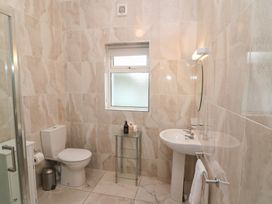 A bathroom with a toilet, sink and shower at No 1 Lodge Wood, Kenmare, County Kerry