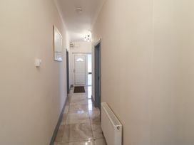 A hallway with a front door and mirror at No 1 Lodge Wood, Kenmare, County Kerry