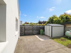 An outdoor space with a shed and green bin at No 1 Lodge Wood Kenmare, County Kerry