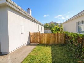 An outdoor area with a fence and grass at No 1 Lodge Wood, Kenmare, County Kerry