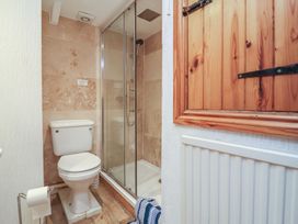A bathroom with a toilet and a shower at Cobblestone Cottage Bude