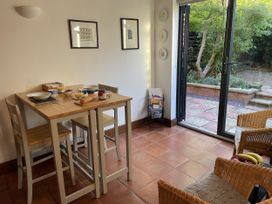 A kitchen with a table and chairs at Old Town Cottage in Stratford-Upon-Avon