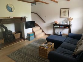 A living room with a sofa and television at Old Town Cottage in Stratford-Upon-Avon