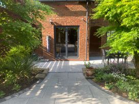 A garden with a pathway and seating area at Old Town Cottage Stratford-Upon-Avon
