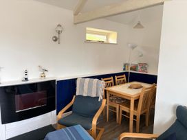 A dining area with chairs and a table at Lighthouse Cottage St Erme near Truro