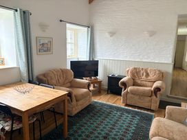 A living room with seating and a television at Sunlight Cottage in St Erme near Truro