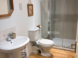 A bathroom with a sink, toilet, and shower at Sunlight Cottage St Erme near Truro