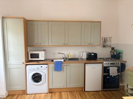 A kitchen with appliances and fixtures at Sunlight Cottage in St Erme near Truro