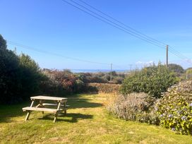 A garden with a picnic table and shrubs at Merriview Ashton Nr Helston