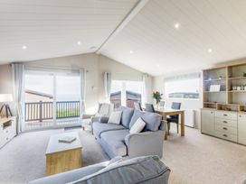 A living room with a sofa and table at Lodge 66 at Riviera Bay Coastal Retreat Brixham
