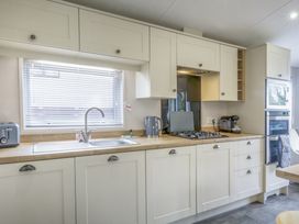 A kitchen with appliances and a sink at Lodge 55 at Riviera Bay Coastal Retreat Brixham
