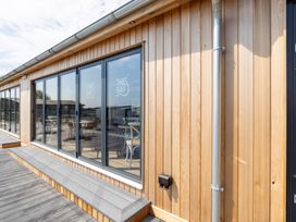 An outdoor view of a wooden building with large windows at Lodge 58 at Riviera Bay Coastal Retreat Brixham