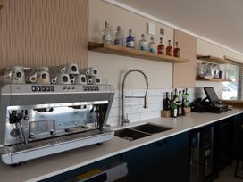 A kitchen with a coffee machine and bar supplies at Lodge 58 at Riviera Bay Coastal Retreat Brixham