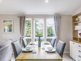 A dining room with a table set for a meal at Lodge 58 at Riviera Bay Coastal Retreat Brixham