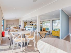 A dining room with tables and bar area at Lodge 59 at Riviera Bay Coastal Retreat Brixham