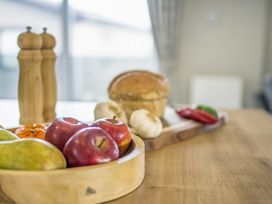 A kitchen with fruit and vegetables on a table at Lodge 63 at Riviera Bay Coastal Retreat Brixham