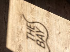 A shadow on wooden flooring at Lodge 71 at Riviera Bay Coastal Retreat in Brixham