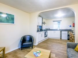 A kitchen area with a dining table at Chalet 7 at Landscove Holiday Park Brixham