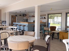 A dining room with tables and chairs at Lodge 73 at Riviera Bay Coastal Retreat in Brixham