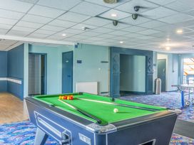 A game room with a pool table and doors at Chalet 29 at Landscove Holiday Park Brixham