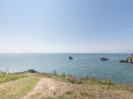 A view of the sea and islands from a grassy path at Lodge 9 at Landscove Holiday Park Brixham