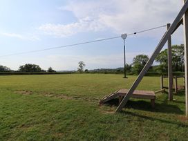 An outdoor area with a zip line and play structure at Metcalfe House in Compton Dundon