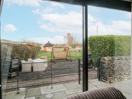 A garden view with a swing and outdoor furniture at 1 Gilpin House Levens