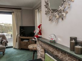 A living room with a sofa and television at 1 Gilpin House Levens