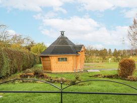 A wooden cabin viewed from a garden at 1 Gilpin House Levens