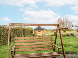 A swing in a garden with a shed in the background at 1 Gilpin House Levens