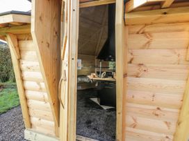 A wooden structure with a kitchen area visible at 1 Gilpin House Levens