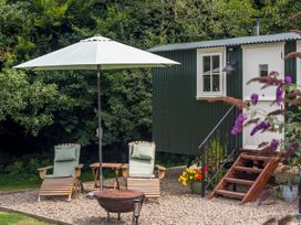 An outdoor area with deck chairs and an umbrella at Collen Aberaeron