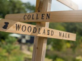 Wooden sign indicating COLLEN and WOODLAND WALK at Bedwen in Aberaeron