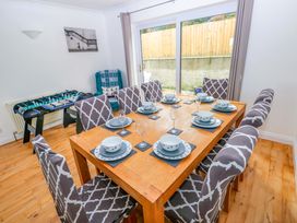 A dining room with a table set for dinner at 15 Lawnswood Saundersfoot