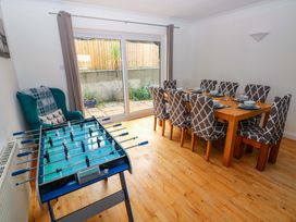 A dining room with a foosball table and dining table at 15 Lawnswood in Saundersfoot
