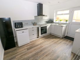 A kitchen with appliances and cabinets at 15 Lawnswood in Saundersfoot
