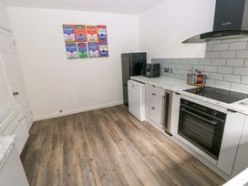A kitchen with a refrigerator and microwave at 15 Lawnswood in Saundersfoot